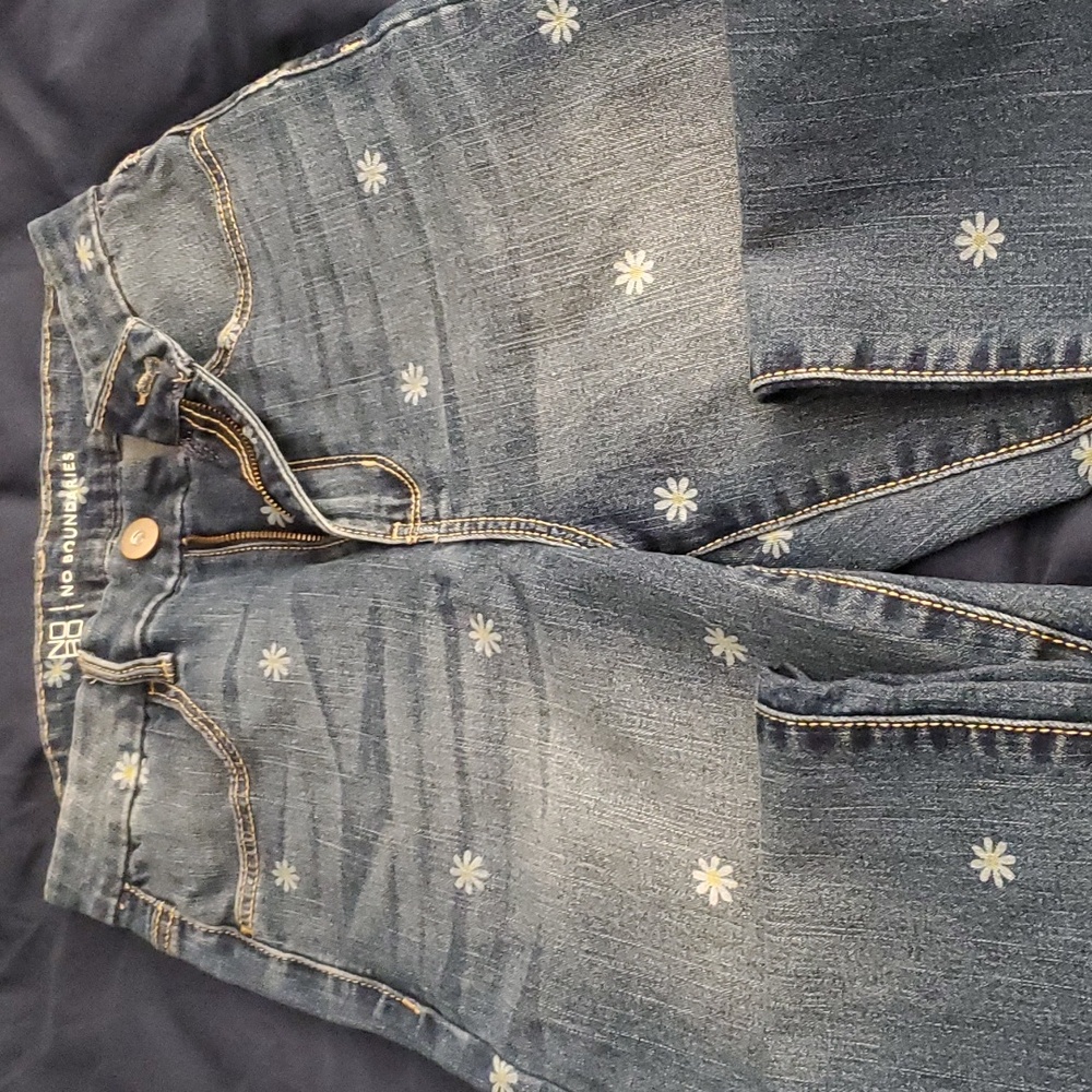 Skinny jeans, faded with  frayed legs. Size 7, with small faded daisy pattern.